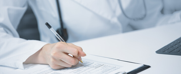 A dentist signing an employment contract at a new practice