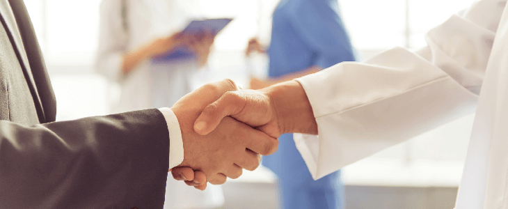 Two dentists shaking hands
