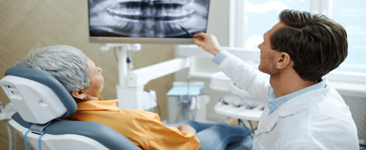 dentist speaking with patient and showing her the xrays