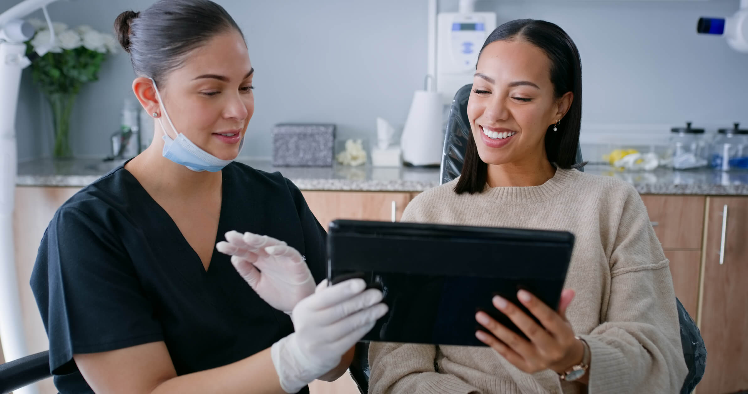 Dentist, tablet results and discussion with woman patient for teeth cleaning or surgery at a clinic. Dental info, doctor and healthcare with surgeon and health conversation in a hospital for wellness