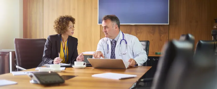 A dentist peaking with a dental law attorney